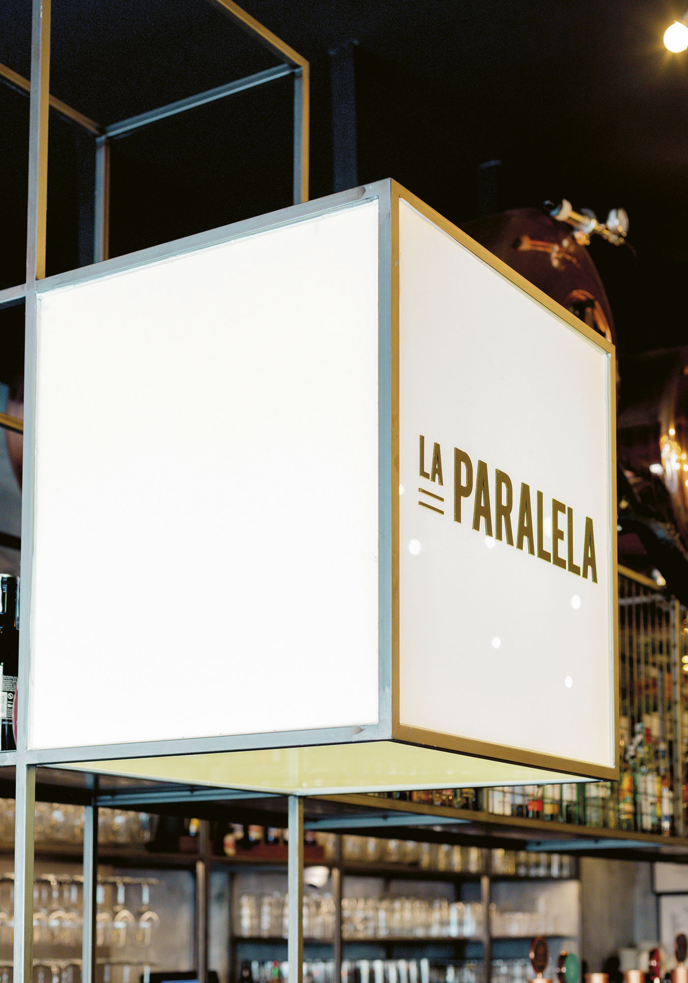 Imagen de un cubo de metacrilato con planchas adhesivadas para el restaurante "La Paralela" con letras de hierro